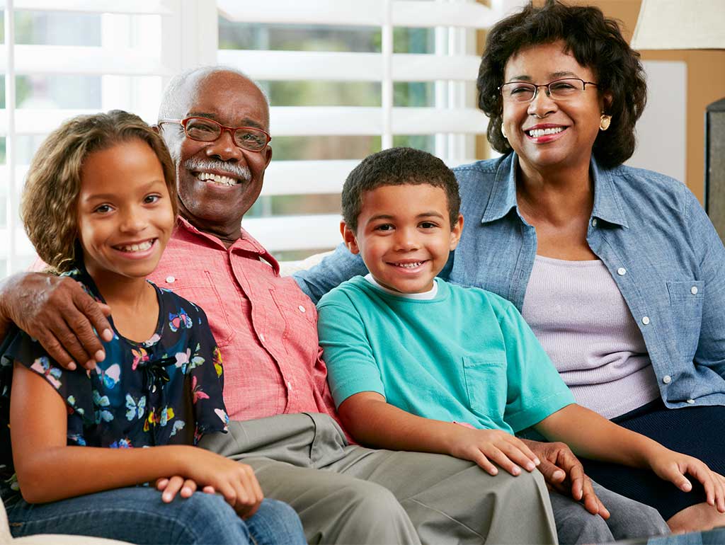 Grandparents on couch with grandchildren