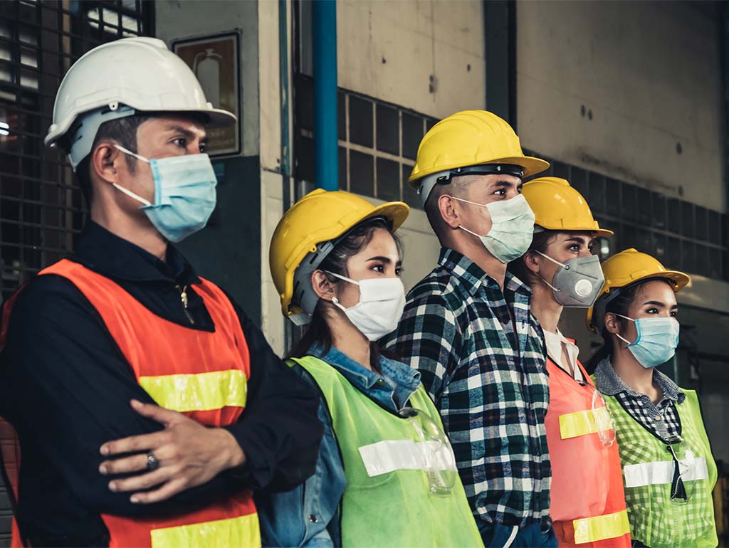 Workers with vests and face masks